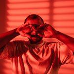 person bathed in red light who appears to have trouble sleeping