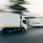 Photo of moving truck on a road. This photo is used to accompany a blog post about our office relocation.