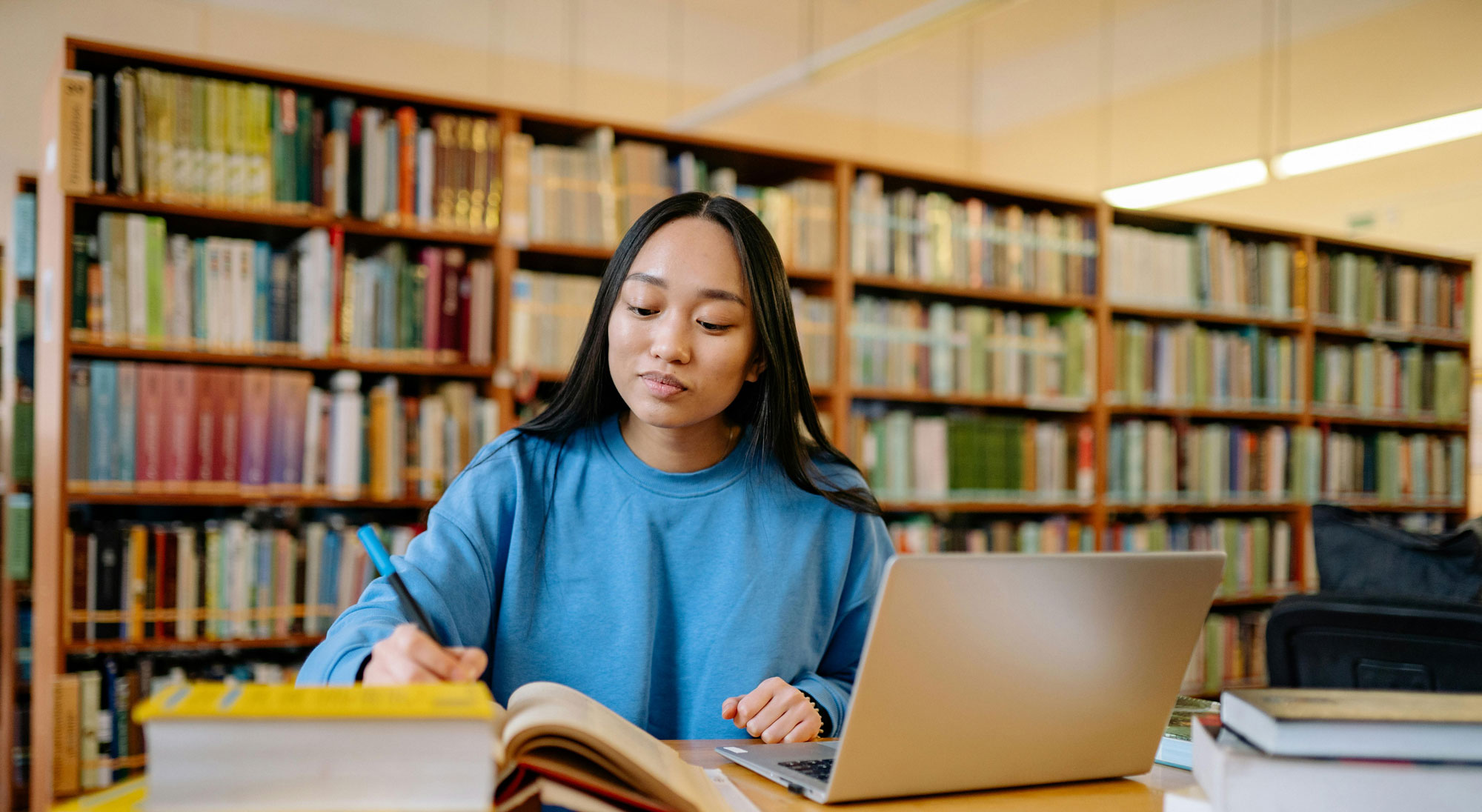 Person studying within a library setting
